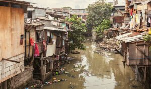 Shacks in a slum area along a small polluted canal. Manila, Philippines. istockphoto 637482404 612x612 1 - Rembang