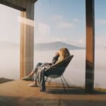Young woman sips hot beverage on modern deck at mountain home istockphoto 2128320978 640x640 1 - Lifestyle
